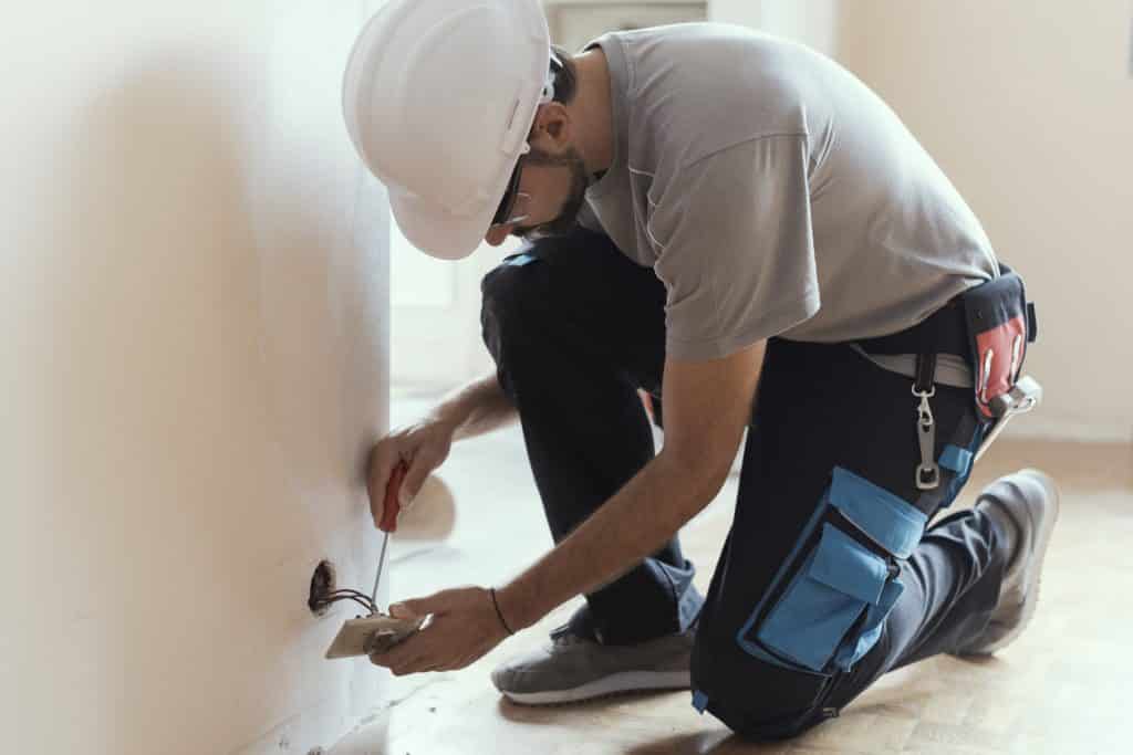 Professional electrician, installing sockets at home